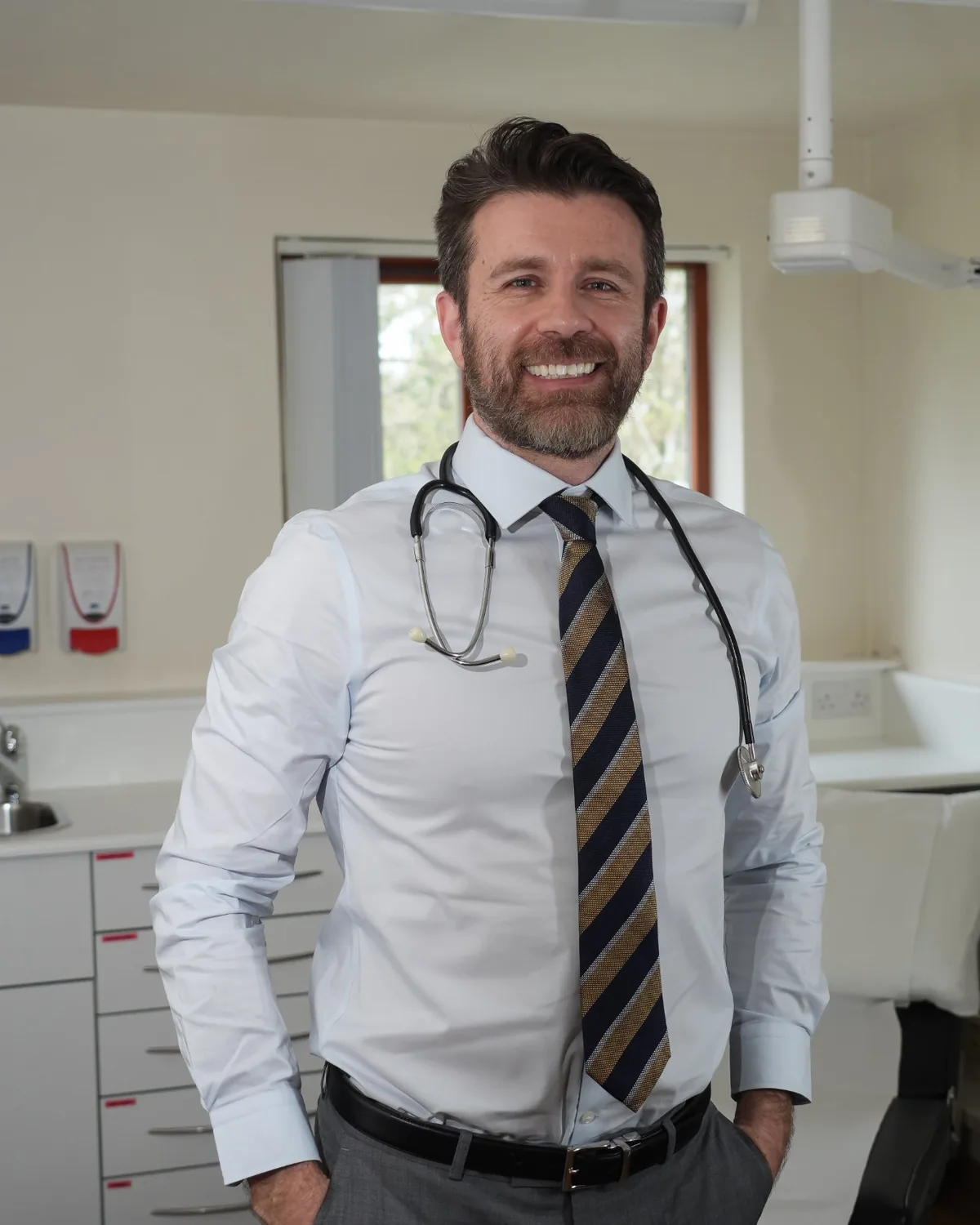 Dr Dan Reardon standing in his consulting room